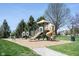 Community playground with slides, swings, and play structures, surrounded by trees and green grass at 11327 Guy St, Fishers, IN 46038