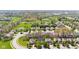 A sunny aerial view shows a residential neighborhood with mature trees and green spaces at 11651 Beardsley Way, Fishers, IN 46038