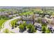 A sunny aerial view shows a residential neighborhood with mature trees and green spaces at 11651 Beardsley Way, Fishers, IN 46038