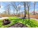 Fenced backyard with green grass, a patio, a fire pit, and a garden bed offer outdoor enjoyment at 11651 Beardsley Way, Fishers, IN 46038