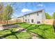 Fenced backyard with green grass, a fire pit, and a garden bed offer outdoor enjoyment at 11651 Beardsley Way, Fishers, IN 46038