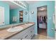 Bright blue bathroom with a dual sink vanity, large mirror, and convenient walk-in closet at 11651 Beardsley Way, Fishers, IN 46038