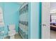 Bright bathroom featuring a toilet and patterned shower curtain, accented by light blue walls at 11651 Beardsley Way, Fishers, IN 46038