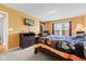 Inviting bedroom featuring a wooden dresser, TV, and a cozy decorative bedspread at 11651 Beardsley Way, Fishers, IN 46038