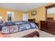 Spacious bedroom with ample closet space, TV, dresser and a large wooden bed at 11651 Beardsley Way, Fishers, IN 46038