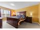 Warm bedroom with a large bed, matching nightstands, and soft carpet at 11651 Beardsley Way, Fishers, IN 46038