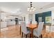 Elegant dining area features hardwood floors, seamlessly connected to the modern, well-equipped kitchen at 11651 Beardsley Way, Fishers, IN 46038