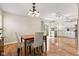 Charming dining area with natural light and hardwood floors leads to a bright, modern kitchen at 11651 Beardsley Way, Fishers, IN 46038