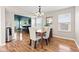 Comfortable dining area with hardwood floors opens to a spacious living room and windows at 11651 Beardsley Way, Fishers, IN 46038