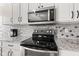 Modern kitchen showcasing stainless steel appliances, granite countertops and white cabinets at 11651 Beardsley Way, Fishers, IN 46038