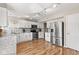 Modern kitchen features white cabinets, stainless steel appliances, and ample counter space at 11651 Beardsley Way, Fishers, IN 46038