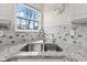 Bright kitchen featuring a stainless steel sink, granite countertops, and decorative backsplash at 11651 Beardsley Way, Fishers, IN 46038