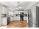 Bright kitchen features white cabinets, stainless steel appliances, and stylish backsplash at 11651 Beardsley Way, Fishers, IN 46038