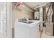 Functional laundry room with modern white washer and dryer, plus ample shelving at 11651 Beardsley Way, Fishers, IN 46038
