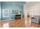 Spacious living room featuring hardwood floors, vaulted ceilings, and a cozy fireplace at 11651 Beardsley Way, Fishers, IN 46038