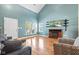 Cozy living room with comfortable seating, hardwood floors, and a decorative fireplace at 11651 Beardsley Way, Fishers, IN 46038