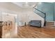 Spacious open-concept living room and dining room boasting hardwood floors and staircase at 11651 Beardsley Way, Fishers, IN 46038