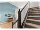 Carpeted staircase with dark wood railing leading to the upper level of the home at 11651 Beardsley Way, Fishers, IN 46038