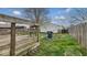 Wooden backyard deck overlooking the lawn and garage with wooden fence, and mature trees at 122 S 3Rd Ave, Beech Grove, IN 46107
