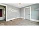 Bedroom with carpet, grey walls, and door to hall at 122 S 3Rd Ave, Beech Grove, IN 46107