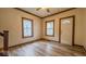 Entryway featuring wood look floors, staircase and windows at 122 S 3Rd Ave, Beech Grove, IN 46107