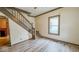 View of the entryway showing wood look floors and staircase at 122 S 3Rd Ave, Beech Grove, IN 46107
