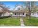 Charming home with a well-maintained lawn, a pathway and mature tree in front yard at 122 S 3Rd Ave, Beech Grove, IN 46107