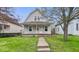 Charming two-story home with a gambrel roof and inviting front yard and porch at 122 S 3Rd Ave, Beech Grove, IN 46107