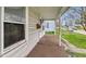 Covered front porch with stone pillars and a view of the front yard and quiet street at 122 S 3Rd Ave, Beech Grove, IN 46107