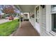 Covered front porch with stone pillars and a view of the front yard and quiet street at 122 S 3Rd Ave, Beech Grove, IN 46107