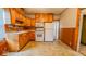 Traditional kitchen features wood cabinets, white appliances, and durable flooring at 122 S 3Rd Ave, Beech Grove, IN 46107