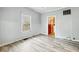 Inviting living room featuring natural light, ceiling fan, and updated flooring at 122 S 3Rd Ave, Beech Grove, IN 46107