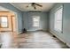 Inviting living room featuring natural light, ceiling fan, and updated flooring at 122 S 3Rd Ave, Beech Grove, IN 46107