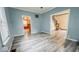 Inviting living room featuring natural light, ceiling fan, and updated flooring at 122 S 3Rd Ave, Beech Grove, IN 46107