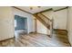 Spacious living room with staircase and wood-look floors at 122 S 3Rd Ave, Beech Grove, IN 46107