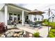 This spacious back porch offers multiple seating areas and a barbecue grill, with a stone feature for added interest at 1242 Petit Verdot Dr, Westfield, IN 46074