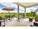 This back porch has both cushioned chairs and metal frame seating to provide different seating options and views of the lawn at 1242 Petit Verdot Dr, Westfield, IN 46074