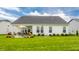 A well-maintained backyard features a large patio and manicured lawn for outdoor enjoyment at 1242 Petit Verdot Dr, Westfield, IN 46074