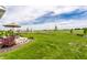 The lush backyard has a patio with various seating arrangements and a well-manicured lawn at 1242 Petit Verdot Dr, Westfield, IN 46074