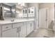 Well-lit bathroom featuring a wide vanity with white cabinetry and a large mirror at 1242 Petit Verdot Dr, Westfield, IN 46074