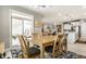Sunlit dining room features wood table, chairs, decorative rug, and slider to patio at 1242 Petit Verdot Dr, Westfield, IN 46074