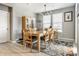 Dining room features a wood table, chairs, decorative rug, and natural light from the windows at 1242 Petit Verdot Dr, Westfield, IN 46074