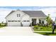Charming two-story home featuring a three-car garage, complemented by a well-manicured lawn and lush landscaping at 1242 Petit Verdot Dr, Westfield, IN 46074