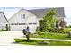 Beautiful home with a manicured lawn, young trees, and an inviting mailbox, blending curb appeal with natural beauty at 1242 Petit Verdot Dr, Westfield, IN 46074