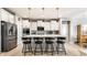 Well-lit kitchen boasts stainless steel appliances, island with seating, and ample white cabinetry at 1242 Petit Verdot Dr, Westfield, IN 46074