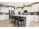 Spacious kitchen features stainless steel appliances, island with seating, and stylish pendant lighting at 1242 Petit Verdot Dr, Westfield, IN 46074