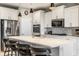 Bright kitchen showcases a large island with seating, stainless appliances, and white cabinets at 1242 Petit Verdot Dr, Westfield, IN 46074