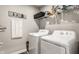 This laundry room features a washer and dryer set, along with shelving for storage and a decorative 'Laundry' sign at 1242 Petit Verdot Dr, Westfield, IN 46074