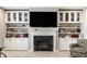 Cozy fireplace and custom built-in shelving create an inviting focal point in this beautifully lit living room at 1242 Petit Verdot Dr, Westfield, IN 46074