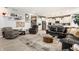 Spacious living area featuring a glass coffee table, leather furniture, and an open layout leading to the kitchen at 1242 Petit Verdot Dr, Westfield, IN 46074